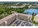An aerial view of an apartment building, showcasing its lakefront location and parking facilities at 3544 Lake Bayshore Dr # K123, Bradenton, FL 34205
