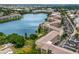 Aerial perspective showcasing waterfront property, buildings, parking lots, and surrounding greenery at 3544 Lake Bayshore Dr # K123, Bradenton, FL 34205