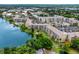Aerial view of waterfront community with multiple buildings, parking, and lush landscaping at 3544 Lake Bayshore Dr # K123, Bradenton, FL 34205