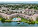 Aerial view of condo buildings near a lake with a pool at 3544 Lake Bayshore Dr # K123, Bradenton, FL 34205