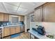 Well-equipped kitchen with light wood cabinets and stainless steel appliances at 3544 Lake Bayshore Dr # K123, Bradenton, FL 34205