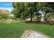 Community lawn with shuffleboard and bocce ball courts under a large tree at 3544 Lake Bayshore Dr # K123, Bradenton, FL 34205