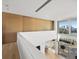 Modern hallway with light wood floors and wood wall at 3638 San Remo Ter, Sarasota, FL 34239