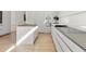 Modern white kitchen with island and wood flooring at 3638 San Remo Ter, Sarasota, FL 34239