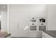 Modern kitchen with built in appliances and white cabinets at 3638 San Remo Ter, Sarasota, FL 34239