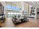 Bright living room with water views, large windows, and modern furniture at 3638 San Remo Ter, Sarasota, FL 34239