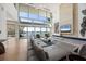 Open living room with water views and modern, gray sectional sofa at 3638 San Remo Ter, Sarasota, FL 34239