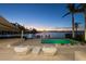 Modern pool and patio furniture at sunset, overlooking the water at 3638 San Remo Ter, Sarasota, FL 34239