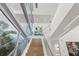 Modern staircase with glass railings and light wood steps at 3638 San Remo Ter, Sarasota, FL 34239