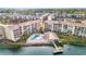 Aerial view of waterfront community with pool, dock, and building at 3751 Lake Bayshore Dr # H304, Bradenton, FL 34205
