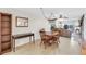 Dining area with wooden table and chairs, open to living room at 3751 Lake Bayshore Dr # H304, Bradenton, FL 34205