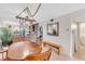 Charming dining room featuring a rustic wooden table and unique lighting fixture at 3751 Lake Bayshore Dr # H304, Bradenton, FL 34205
