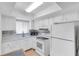 Efficient kitchen with white cabinets and appliances at 3751 Lake Bayshore Dr # H304, Bradenton, FL 34205
