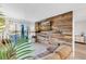 Living room with a rustic wood wall and a view at 3751 Lake Bayshore Dr # H304, Bradenton, FL 34205