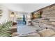 Spacious living room with a large TV and sliding glass doors leading to a balcony at 3751 Lake Bayshore Dr # H304, Bradenton, FL 34205