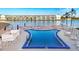 Community pool with surrounding patio furniture at 3751 Lake Bayshore Dr # H304, Bradenton, FL 34205