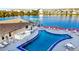 Community pool with lake view; deck furniture and waterfront access at 3751 Lake Bayshore Dr # H304, Bradenton, FL 34205