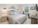 Bright bedroom featuring a comfortable bed and a small work area at 3810 82Nd Avenue E Cir # 102, Sarasota, FL 34243