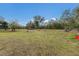 Open pasture with sparse vegetation and a few hay bales at 38355 State Road 64 E, Myakka City, FL 34251