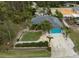House with teal garage door, landscaping, and surrounding trees at 3972 Titan St, North Port, FL 34286