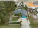 Aerial view of single-Gathering home with a large backyard and surrounding trees at 3972 Titan St, North Port, FL 34286