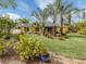 Tropical landscaping surrounds this charming home's backyard, featuring lush foliage and a relaxing patio area at 3972 Titan St, North Port, FL 34286
