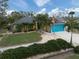 House exterior: yellow house with teal accents, landscaping, and American flag at 3972 Titan St, North Port, FL 34286