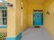 Teal front door entryway with yellow walls and decorative accents at 3972 Titan St, North Port, FL 34286