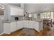 White kitchen cabinets and granite countertops with breakfast bar at 3972 Titan St, North Port, FL 34286