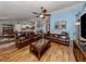 Open living room with hardwood floors and brown leather sofas at 3972 Titan St, North Port, FL 34286