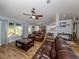 Relaxing living room with hardwood floors and brown leather sofas at 3972 Titan St, North Port, FL 34286