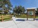 Park entrance with a wooden fence, trail, and information kiosk at 3972 Titan St, North Port, FL 34286