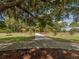 Playground entrance with a paved path and lush landscaping at 3972 Titan St, North Port, FL 34286