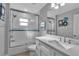Clean bathroom with white vanity and tiled shower at 4310 Zenith Rd, Venice, FL 34293