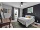 Bedroom with a bed, desk, and dark accent wall at 4310 Zenith Rd, Venice, FL 34293