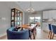 Bright dining area with a wooden table, blue chairs, and access to a patio at 4310 Zenith Rd, Venice, FL 34293