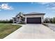 Single-story home with attached garage and landscaped lawn at 4310 Zenith Rd, Venice, FL 34293
