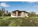 Back of house with screened porch and grassy yard at 4310 Zenith Rd, Venice, FL 34293