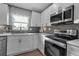Modern kitchen with white cabinets, quartz countertops, and stainless steel appliances at 4310 Zenith Rd, Venice, FL 34293