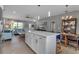 Open concept kitchen boasts a large island, stainless steel appliances, and white shaker cabinets at 4310 Zenith Rd, Venice, FL 34293