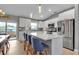Modern kitchen with white cabinets, stainless steel appliances and a large island at 4310 Zenith Rd, Venice, FL 34293