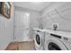 Bright laundry room, Whirlpool washer and dryer, and built-in shelving at 4310 Zenith Rd, Venice, FL 34293