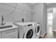 Laundry room with Whirlpool washer and dryer, and built-in shelving at 4310 Zenith Rd, Venice, FL 34293