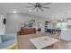 Open living room features hardwood floors, a light-blue sofa, and a view into the kitchen and dining area at 4310 Zenith Rd, Venice, FL 34293