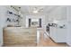 Galley-style kitchen with white cabinetry, wood-look island, and gas range at 4953 Sea Island Ave, Sarasota, FL 34234