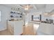 Efficient kitchen with white cabinets, gas stove, and open shelving at 4953 Sea Island Ave, Sarasota, FL 34234
