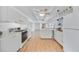 Kitchen with white cabinets, gas range, and view into the living room at 4953 Sea Island Ave, Sarasota, FL 34234