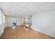 Open living area with light laminate flooring and access to a screened porch at 4953 Sea Island Ave, Sarasota, FL 34234