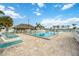 Community pool area with lounge chairs and tiki hut at 4953 Sea Island Ave, Sarasota, FL 34234