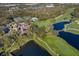 Aerial view of community with clubhouse, golf course, and bridge over water at 5023 Tobermory Way, Bradenton, FL 34211